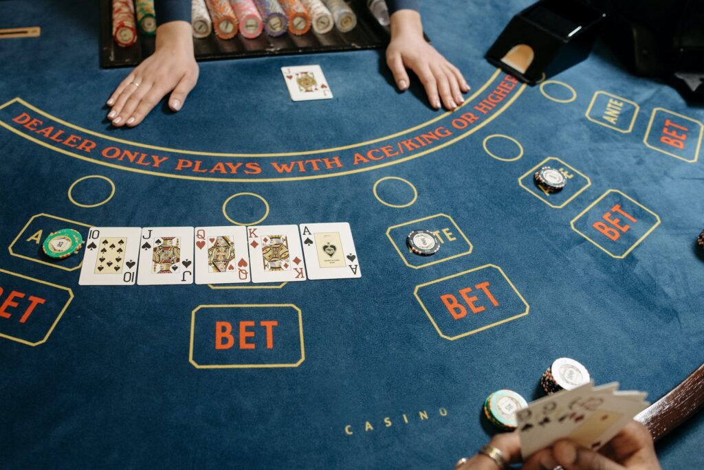 Img source: https://www.pexels.com/photo/cards-and-casino-tokens-on-baccarat-table-7594295/